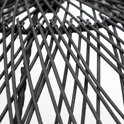 Close-up of black, crisscrossing rattan weaving from The Chapeau Pendant - Black - L against a white background, highlighting the intricate texture and pattern of this stylish pendant light.