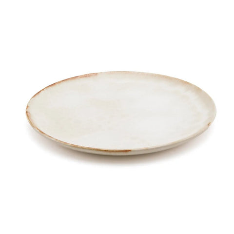 A round, shallow, off-white ceramic plate with a slightly uneven edge and subtle brown speckles along the rim, crafted in the style of Portuguese ceramics and set against a white background.