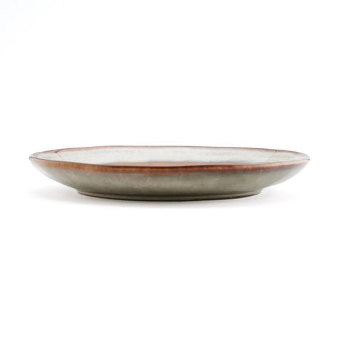 A shallow, round ceramic plate with a muted grayish-green base and a reddish-brown rim, shown from a side view against a plain white background, showcases the artistry of Portuguese ceramics.
