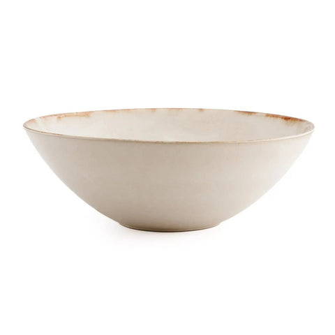 The Cascais Serving Bowl - L is a shallow, round, off-white ceramic bowl with a slightly irregular rim and subtle brown accents, inspired by Portuguese ceramic tradition, shown against a white background.