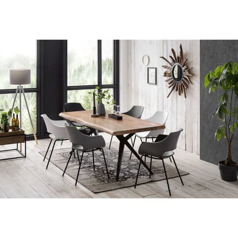 Modern dining room with an Acacia Wood Table 160x85 cm, six white chairs, a decorative rug, large windows, potted plant, tripod floor lamp, and sunburst mirror on a white paneled wall. Natural light fills the inviting space.