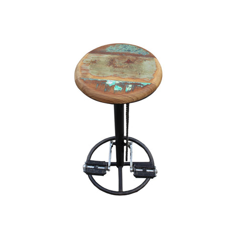 The Industrial Barstool Patina features a tall black metal base, a round weathered reclaimed wood seat, and two bicycle pedals on the footrest—an eye-catching example of bicycle chain furniture.