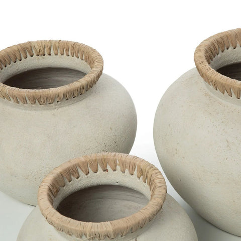 The Styly Vase - Concrete Natural - M features a round, off-white ceramic design with a wide mouth and textured rim wrapped in natural fiber, creating an eco-friendly look against a plain white background.