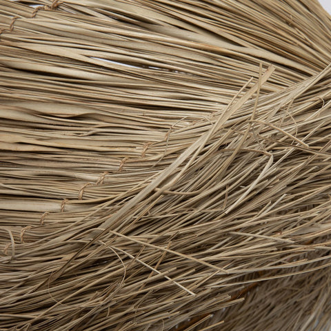 Close-up of The Pandan Table Lamp Shade - Natural, featuring tightly woven, overlapping fibers in beige tones. The image highlights the shade's intricate texture and detailed natural lines.