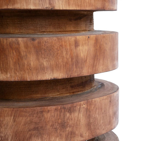 A close-up of The Massaka Stool - Natural showcases the striking grain and beauty of suar wood craftsmanship.
