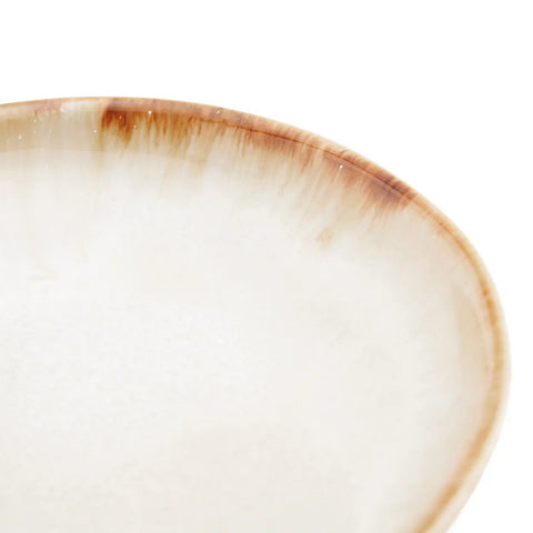 A close-up of The Cascais Appetizer Plate - Set of 6 shows a smooth light beige interior, brown gradient-rimmed edge, glossy, slightly textured finish, and showcases the quality craftsmanship of durable Portuguese ceramics.