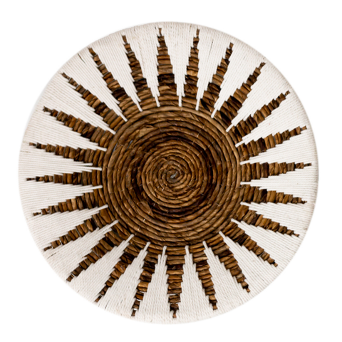 The Decorative Bowl MADALA is a round woven banana fiber basket with a spiral center and radiating dark brown lines, ideal for natural or boho wall decor on a white background.