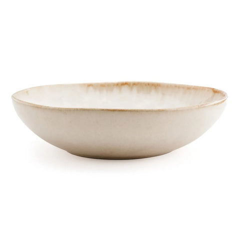A shallow, round ceramic bowl with a slightly uneven rim and a smooth, beige glaze finish, this piece of handmade tableware draws inspiration from Portuguese ceramics and is set against a plain white background.