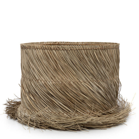 The Pandan Table Lamp Shade - Natural is crafted from woven straw with a tall, cylindrical shape and a slightly frayed brim, resembling a natural hat with visible strands along the edges.