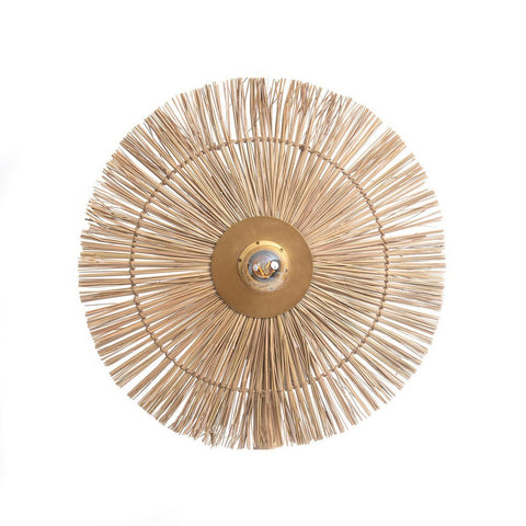 The Beausoleil Wall Lamp - Natural Gold - M is a circular, brass-colored fixture with thin wooden sticks in a sunburst design, adding elegant, sustainable lighting to any space. Featured here is the natural gold finish against a white background.