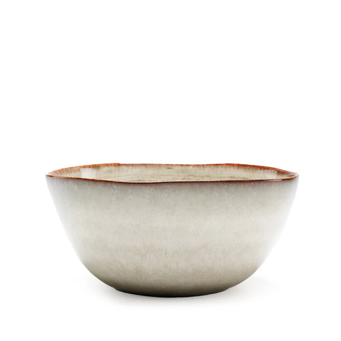 The Comporta Serving Bowl features a matte, light gray ceramic exterior with a slightly irregular rim and thin reddish-brown edge, highlighting the artisanal charm of Portuguese ceramics. Pictured on a plain white background.