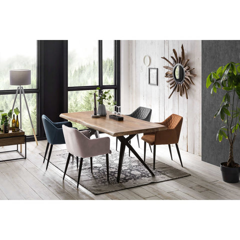 Modern dining room featuring the Acacia Wood Table 160x85 cm, five colorful chairs on a patterned rug, large windows, a standing lamp, a plant, and a sunburst mirror on a white wood-paneled wall.