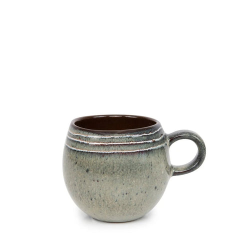 A round, ceramic mug with a large handle, featuring a grayish-green speckled crackle glaze and three horizontal ridges near the rim; the interior is a dark brown color, perfect for lovers of handmade tableware.