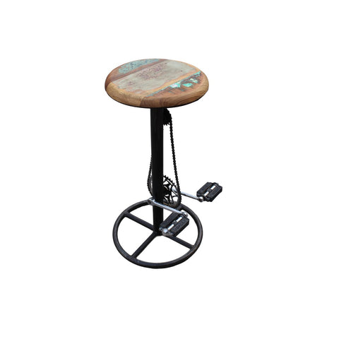The Industrial Barstool Patina is a tall bar stool with a round reclaimed wood seat and a black metal base designed to resemble a bicycle, complete with pedals, chain, and a circular footrest.