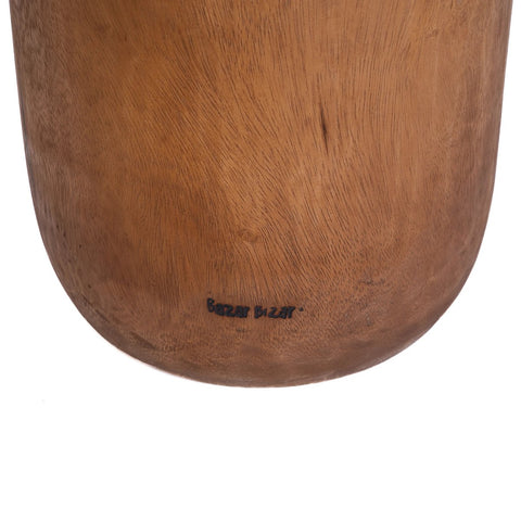 Close-up of the base of The Killa Stool - Natural, made from suar wood with visible wood grain and "Bazar Bizar" printed in black on the bottom. The background is white.
