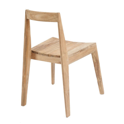 The Paxi Dining Chair - Natural - Outdoor is a minimalist handmade wooden chair with a slanted backrest and angled legs, shown from a rear side view, featuring an unfinished look and crafted sustainably for outdoor use.
