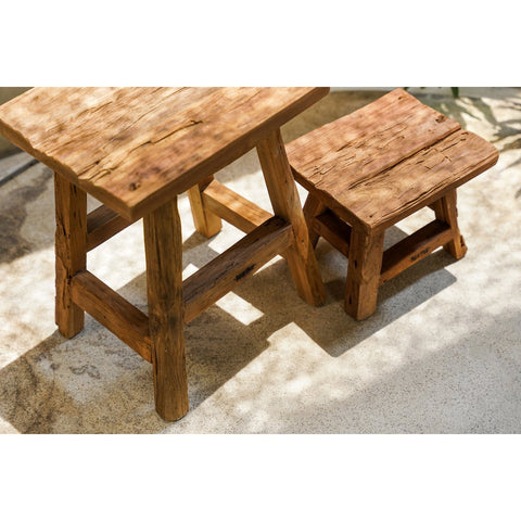 Wooden stool set on a stone surface