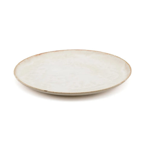 A simple, round, ceramic plate with a slightly irregular edge and a light, off-white glaze—this piece of handmade tableware highlights the timeless beauty of Portuguese ceramics against a white background.
