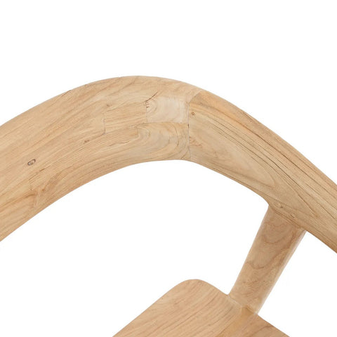 Close-up of the curved backrest and seat of an elegant dining chair, showcasing smooth, light wood grain and precise joints in the craftsmanship.