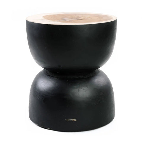 A modern, hourglass-shaped charcoal stool or side table with a smooth black suar wood finish and a natural wood top. The piece features rounded edges and a minimalistic design, perfect for lovers of handmade furniture.