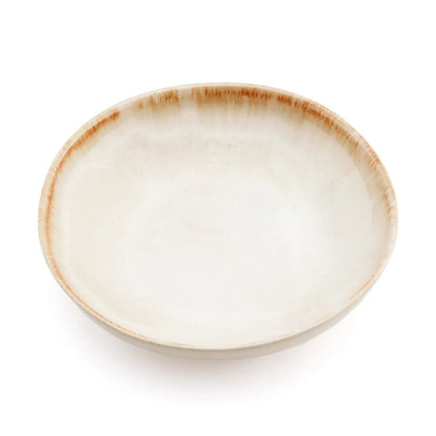 A shallow, round ceramic bowl with a smooth, off-white surface and a slightly textured, light brown rim showcases the beauty of handmade tableware and authentic Portuguese ceramics, set against a white background.
