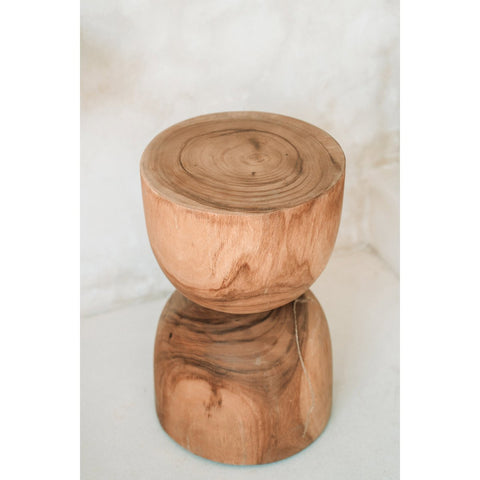 Wooden stool with a natural finish on a light background