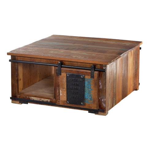 The Chest Coffee Table Patina features a rustic square design with a sliding barn-style door, open storage, a Jupiter Iron Works Est. 1923 metal plate, and a distressed multicolored finish crafted from recycled wood furniture.