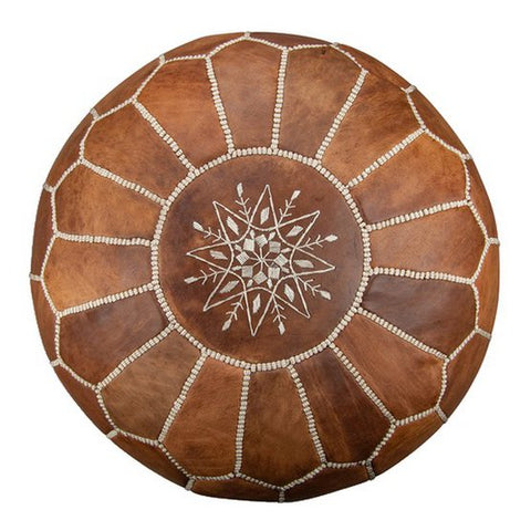 The Leather Pouffe - Cognac Brown is a round, handcrafted Moroccan pouffe featuring white stitched lines radiating from the center and a decorative white embroidered floral pattern in the middle.