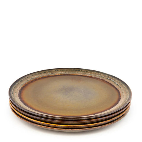 The Comporta Dinner Plate - L - Set of 4 features four round ceramic plates in earthy brown and golden tones with a rustic, textured finish, highlighting handmade charm against a plain white background.