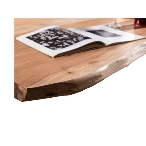The Acacia Wood Table 160x85 cm features a natural, uneven edge and displays an open black-and-white photo book alongside a wine glass on its solid acacia surface.