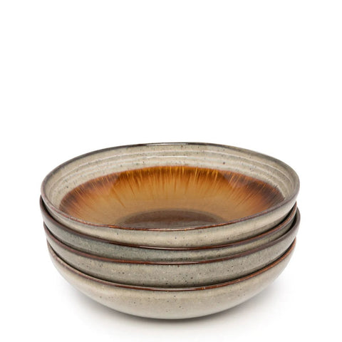 The Comporta Pasta Plate - L - Set of 4 includes four ceramic bowls crafted in Portugal, with a speckled beige exterior and a glossy brown, amber, and orange crackle glaze gradient on the inside.
