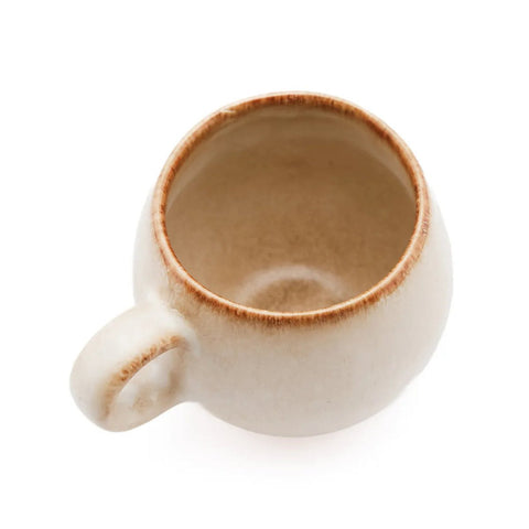 The Cascais Espresso Cup - S - Set of 6 shown from above on a white background. These beige ceramic cups feature round handles and subtly textured light brown rims, reflecting handmade Portuguese-inspired design. Each cup is empty.