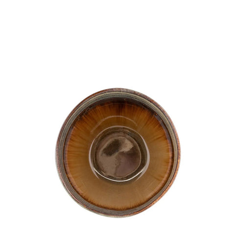 A brown ceramic bowl viewed from above, featuring a glossy, dark center and lighter brown, radiating patterns along the interior sides. This piece of handmade tableware is set against a white background.