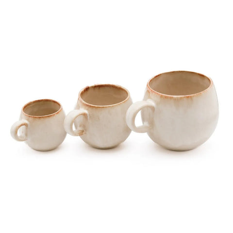 A set of six Cascais Espresso Cups features a rustic white glaze with brownish edges, rounded shapes, and chip-proof durability, capturing the charm of handmade Portuguese ceramics in a compact espresso size.