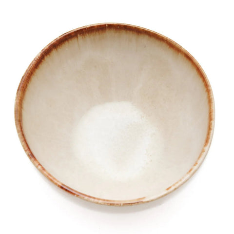 A small amount of white granulated sugar sits at the bottom of a beige ceramic bowl with a brown rim, crafted from durable, chip-proof Portuguese ceramics and shown against a white background.