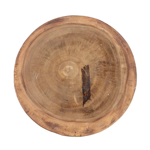The Massaka Stool - Natural features visible wood grain and a dark mark near the center, capturing rustic, artisanal charm. Its earthy brown tone and unfinished look echo the organic beauty of natural wood furniture.
