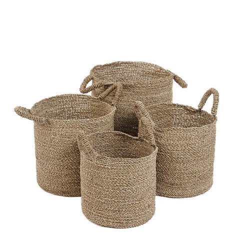 Set of four woven baskets with handles on a white background