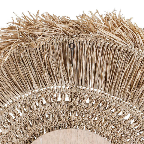 Close-up of a textured woven mirror backside with fringes