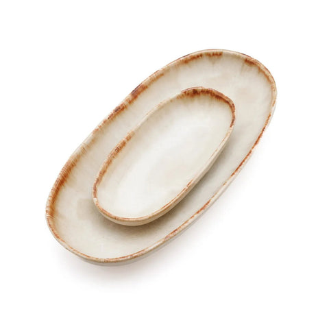 Two oval ceramic serving dishes with a beige glaze and brown-tinted edges, stacked inside each other on a white background—perfect examples of handmade tableware and classic Portuguese ceramics.