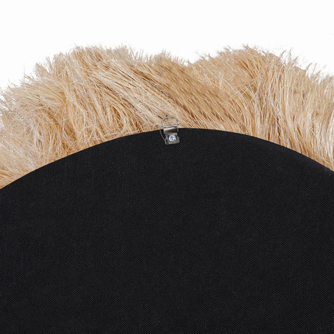 Close-up of a black back of a mirror with beige fringes