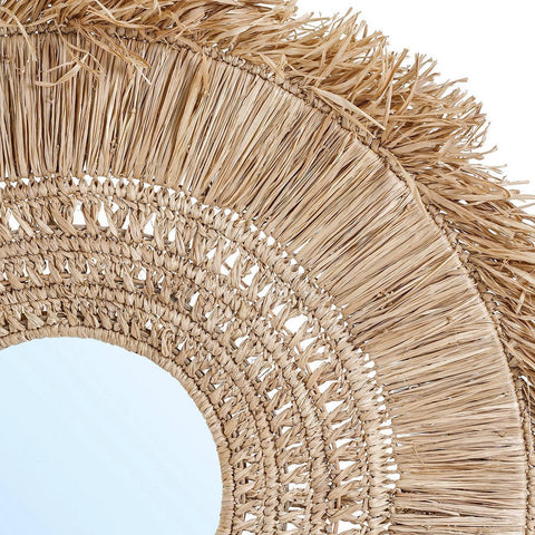 Close-up of a woven mirror with frayed edges