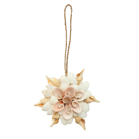 A decorative shell hanger, handmade by Indonesian craftsmen, showcases various seashells arranged in a circular floral pattern. It features a rope loop for hanging. The shells, in shades of beige, pink, and white, lend a natural aesthetic perfect for bohemian decoration.