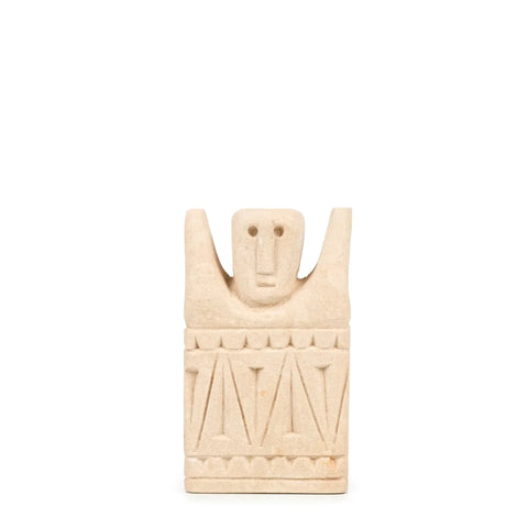 A unique beige stone sculpture, reminiscent of Sumba stone statues, depicts a stylized human figure with raised arms and geometric patterns. The design features a rectangular base adorned with zigzag motifs and a simplified facial expression, showcasing exquisite hand-carved sandstone craftsmanship.