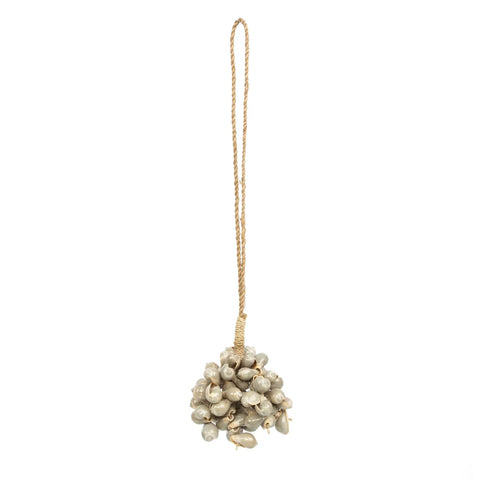 A cluster of small, grayish-white beads resembling berries is carefully attached to a braided beige string, creating a handmade ornament with a bohemian atmosphere. This stylish piece features subtle tassels and hangs gracefully against a plain white background.