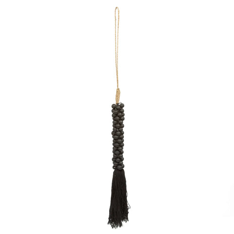 Handmade black beaded tassel with a long fringe and a gold hanging loop, perfect for adding a touch of bohemian atmosphere.