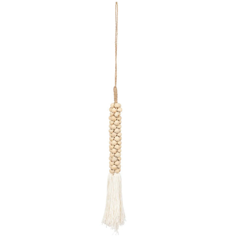 A decorative hanging tassel handcrafted by Balinese craftsmen features a bunch of beige wooden beads threaded in a cylindrical shape. The tassel boasts a loop for easy hanging and white fringe at the bottom, perfect for adding a bohemian touch to any home decoration.