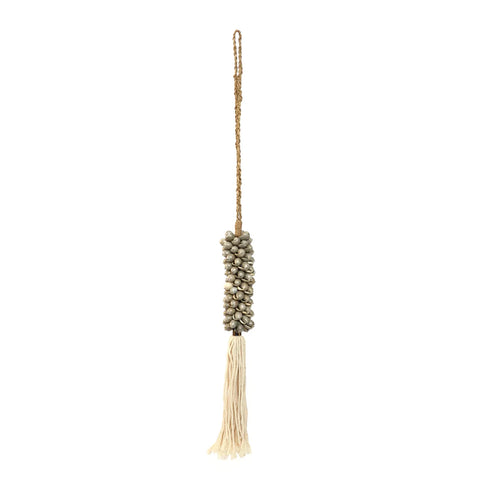 A rustic yet exotic decoration, this hanging piece features a cluster of small gray stones or beads strung with a braided cord. It ends gracefully in a long tassel of light, cream-colored threads, perfect for creating a bohemian atmosphere.