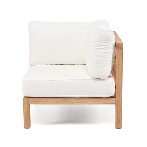 A modern outdoor patio chair crafted from reclaimed teak wood with white cushions. The chair boasts a minimalist, modular design, featuring thick, comfortable seating and backrest cushions.