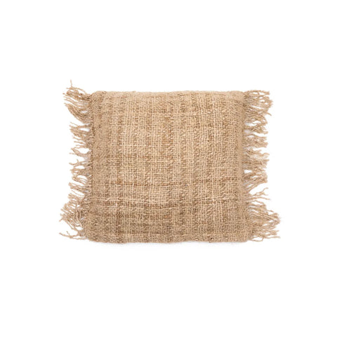 A square, woven boho jute cushion with fringed edges on all sides. The texture is rough and natural, featuring a beige-brown color. This charming cushion is centered against a crisp white background, adding an earthy touch to any space.