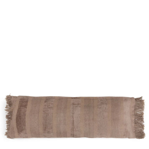 A rectangular brown velvet cushion with subtle striped patterns and fringed edges on both shorter sides adds a boho vibe to any space. The handmade textile offers a slightly textured appearance, making it an exquisite addition to your decor.